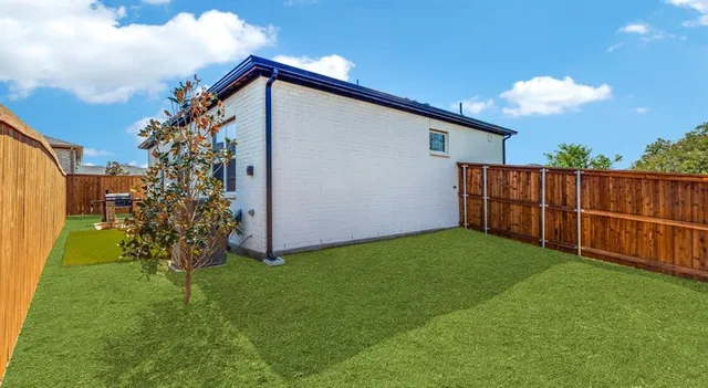 a front view of a house with a garden and plants