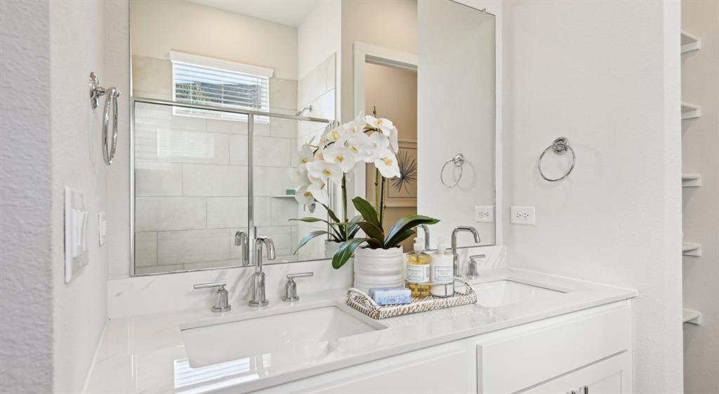3950 Dechman Drive, Unit 2015 Grand Prairie, TX 75052 - Photo 17 of 27 a bathroom with a sink a vanity and a mirror