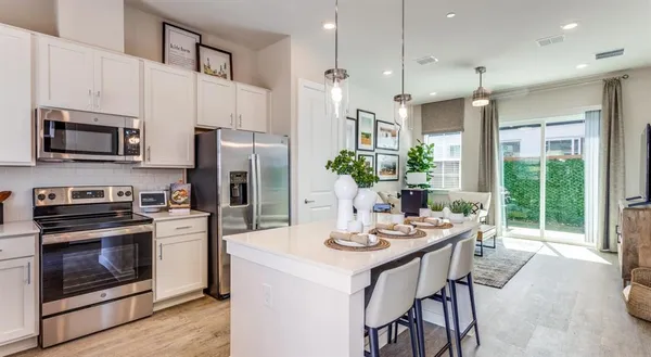 a living room with furniture and kitchen view