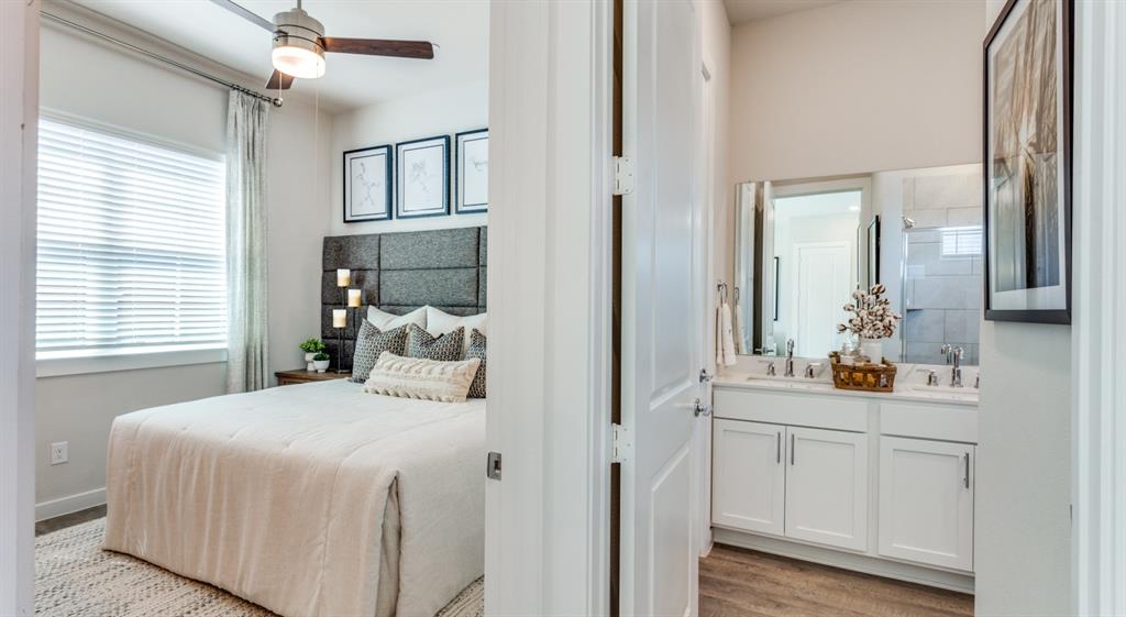 3950 Dechman Drive, Unit 2015 Grand Prairie, TX 75052 - Photo 23 of 27 a bedroom with a bed and a mirror