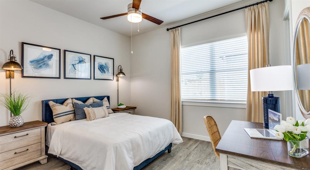 3950 Dechman Drive, Unit 2015 Grand Prairie, TX 75052 - Photo 25 of 27 a bedroom with a large bed and a chandelier