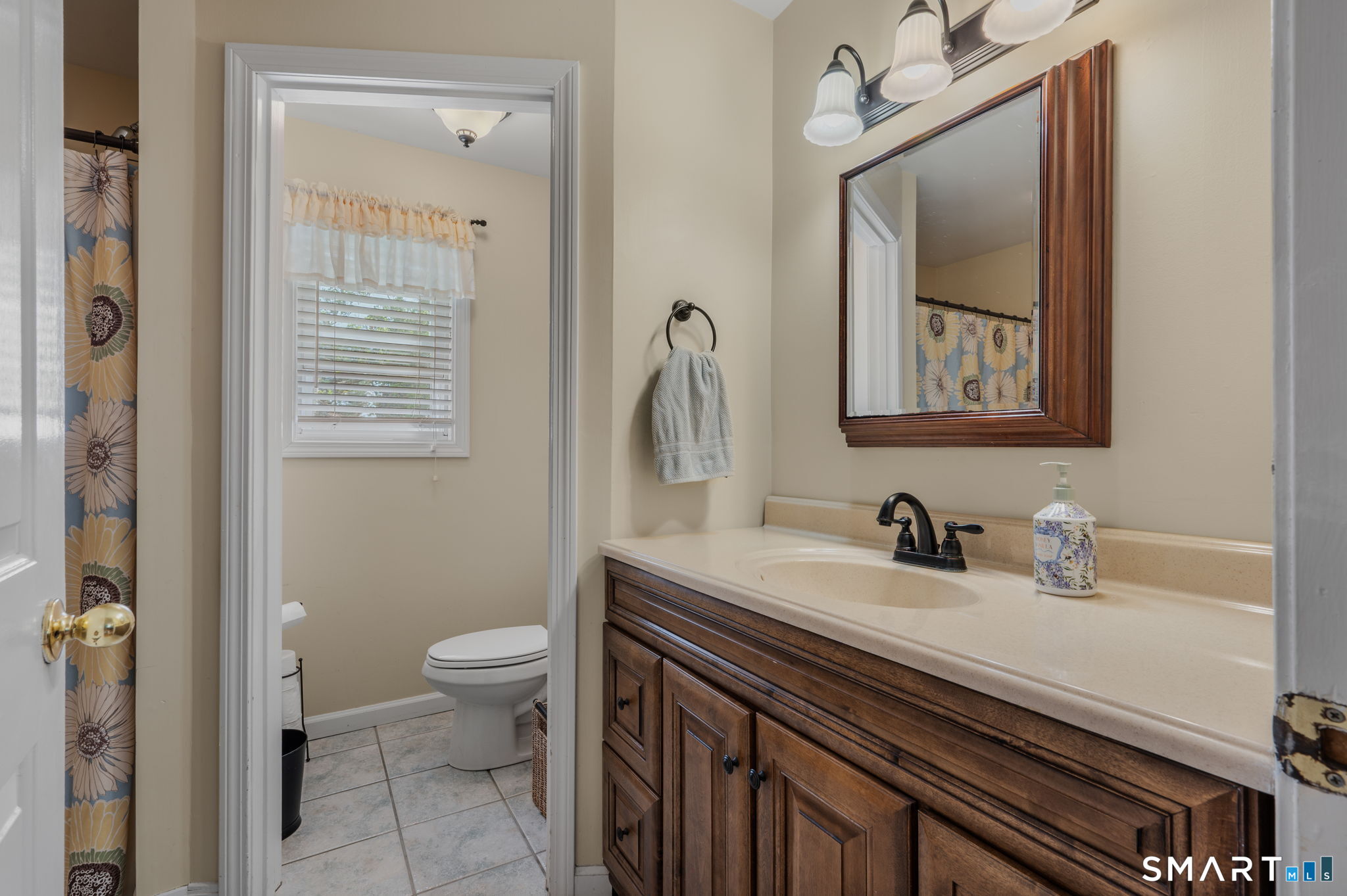 212 R Shore Road Waterford, CT 06385 - Photo 22 of 28 a bathroom with a sink a toilet and a mirror