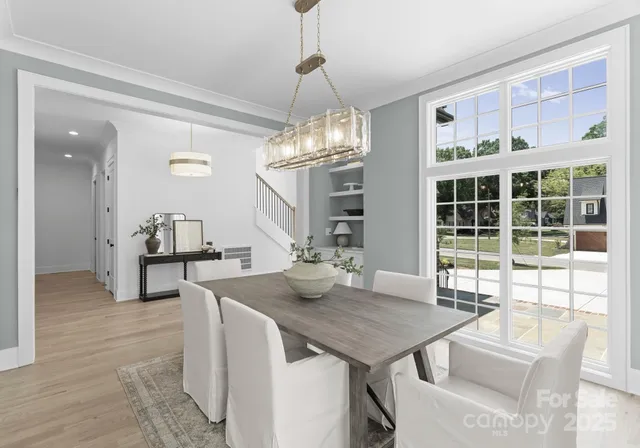 a view of a dining room with furniture and chandelier