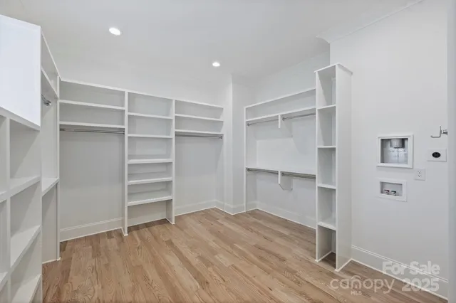 a view of walk in closet with empty racks
