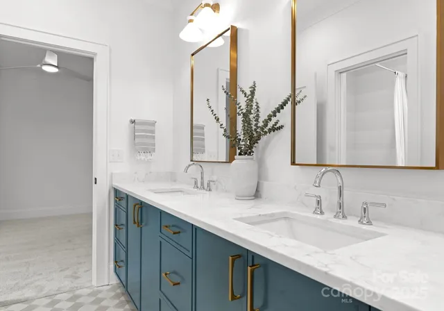 a bathroom with a double vanity sink and a mirror