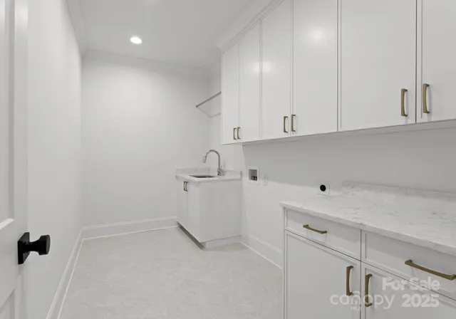 a view of cabinets and utility room with racks on the wall