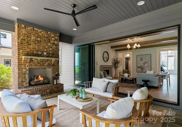 a living room with fireplace furniture and a large window