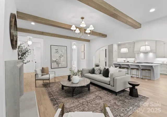 a living room with furniture or chandelier and a table