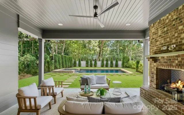 a view of a patio with a table chairs and a backyard