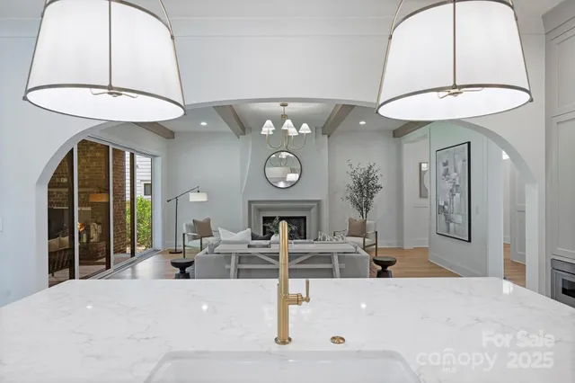 a large kitchen with a table and a large window