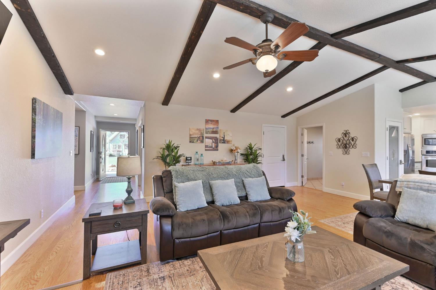 333 Oak Tree Circle Murphys, CA 95247 - Photo 12 of 88 a living room with furniture and a chandelier