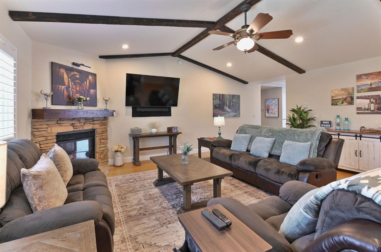 333 Oak Tree Circle Murphys, CA 95247 - Photo 13 of 88 a living room with furniture a flat screen tv and a fireplace
