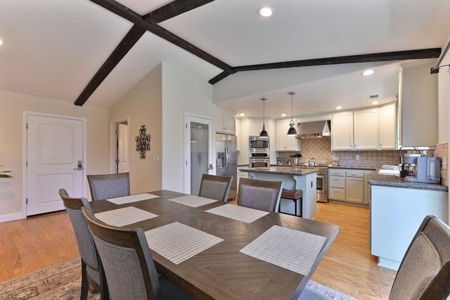 333 Oak Tree Circle Murphys, CA 95247 - Photo 16 of 88 a living room with stainless steel appliances kitchen island granite countertop furniture and a dining table