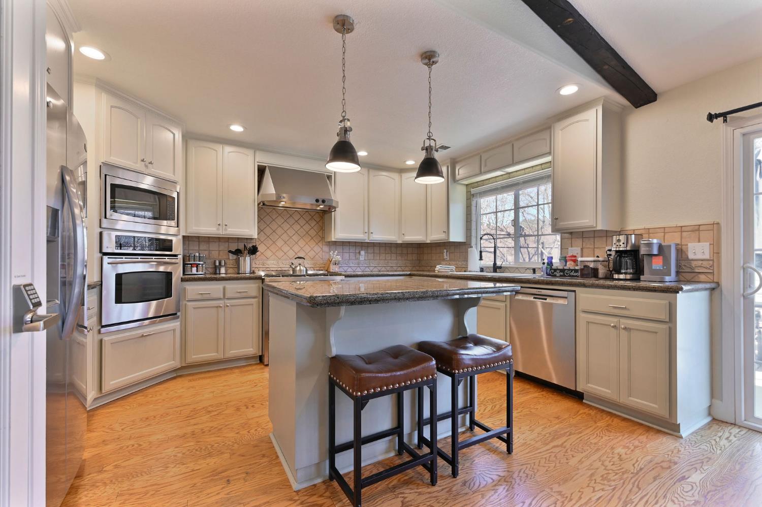 333 Oak Tree Circle Murphys, CA 95247 - Photo 17 of 88 a kitchen with white cabinets and appliances