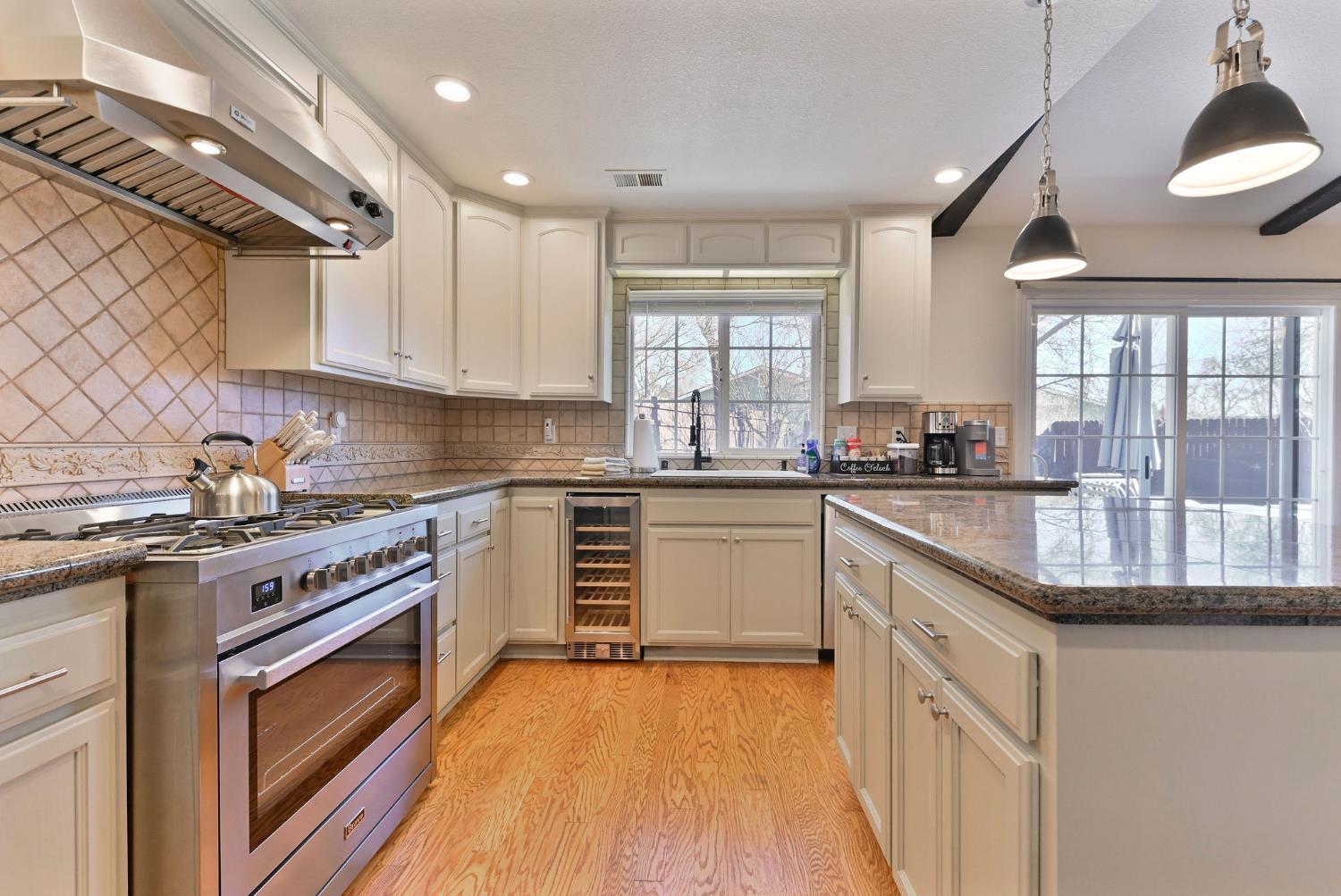 333 Oak Tree Circle Murphys, CA 95247 - Photo 23 of 88 a kitchen with granite countertop a sink a counter top space stainless steel appliances and cabinets