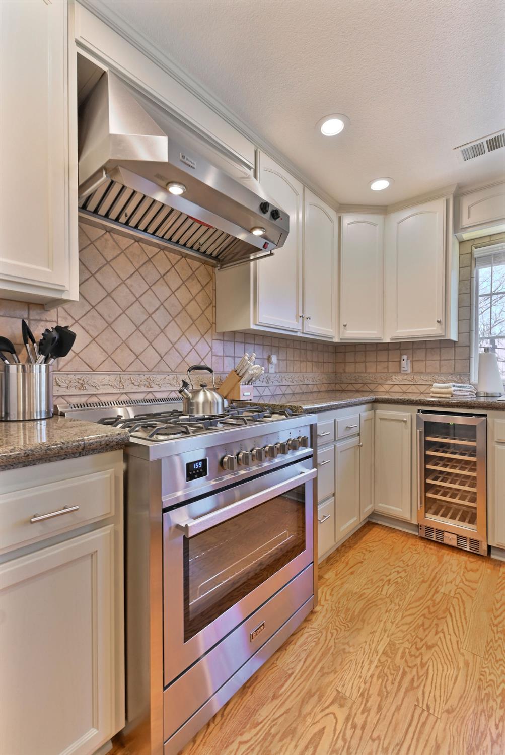 333 Oak Tree Circle Murphys, CA 95247 - Photo 24 of 88 a kitchen with stainless steel appliances granite countertop a stove and a sink