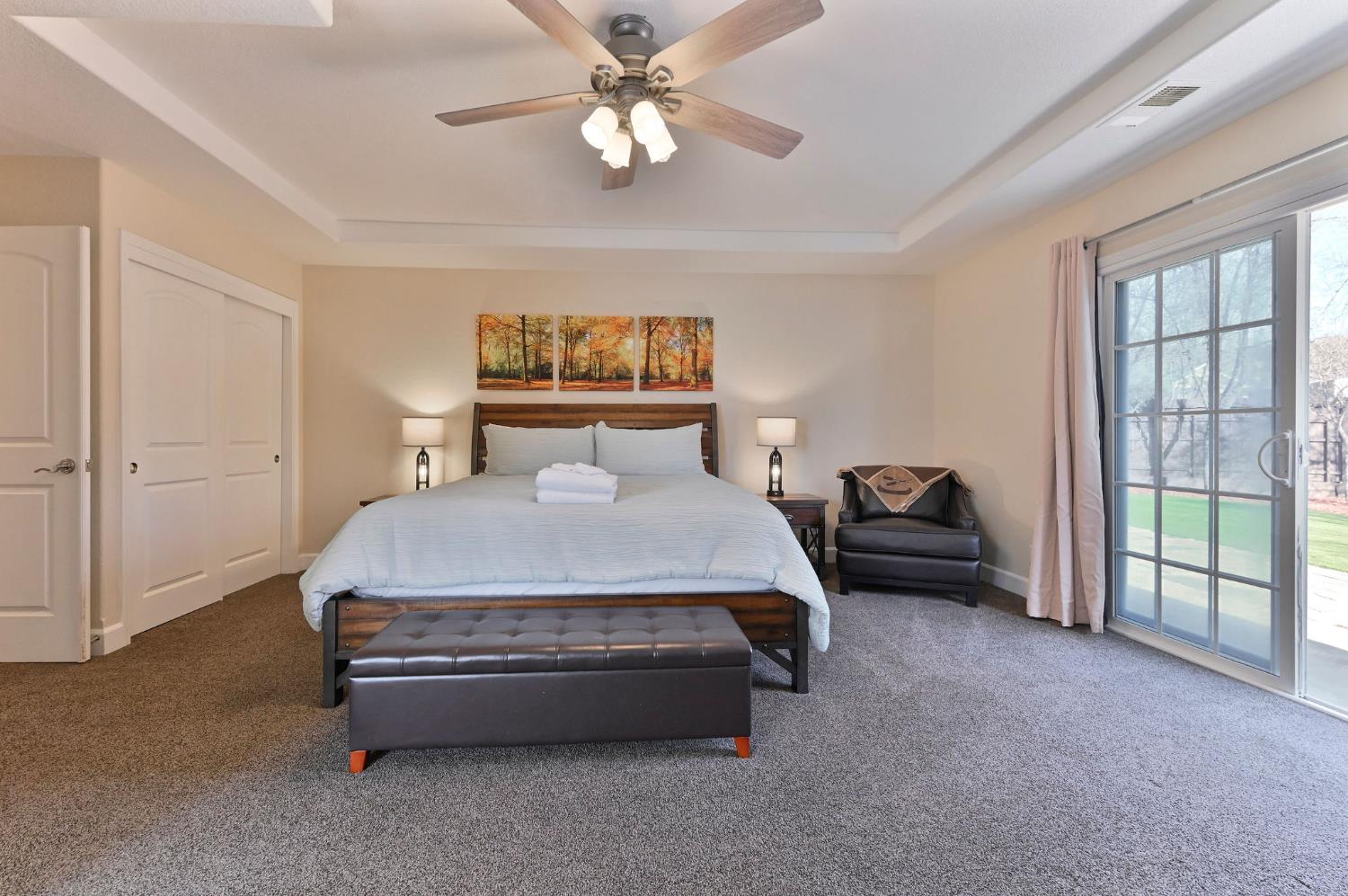 333 Oak Tree Circle Murphys, CA 95247 - Photo 28 of 88 a spacious bedroom with a bed and a chandelier