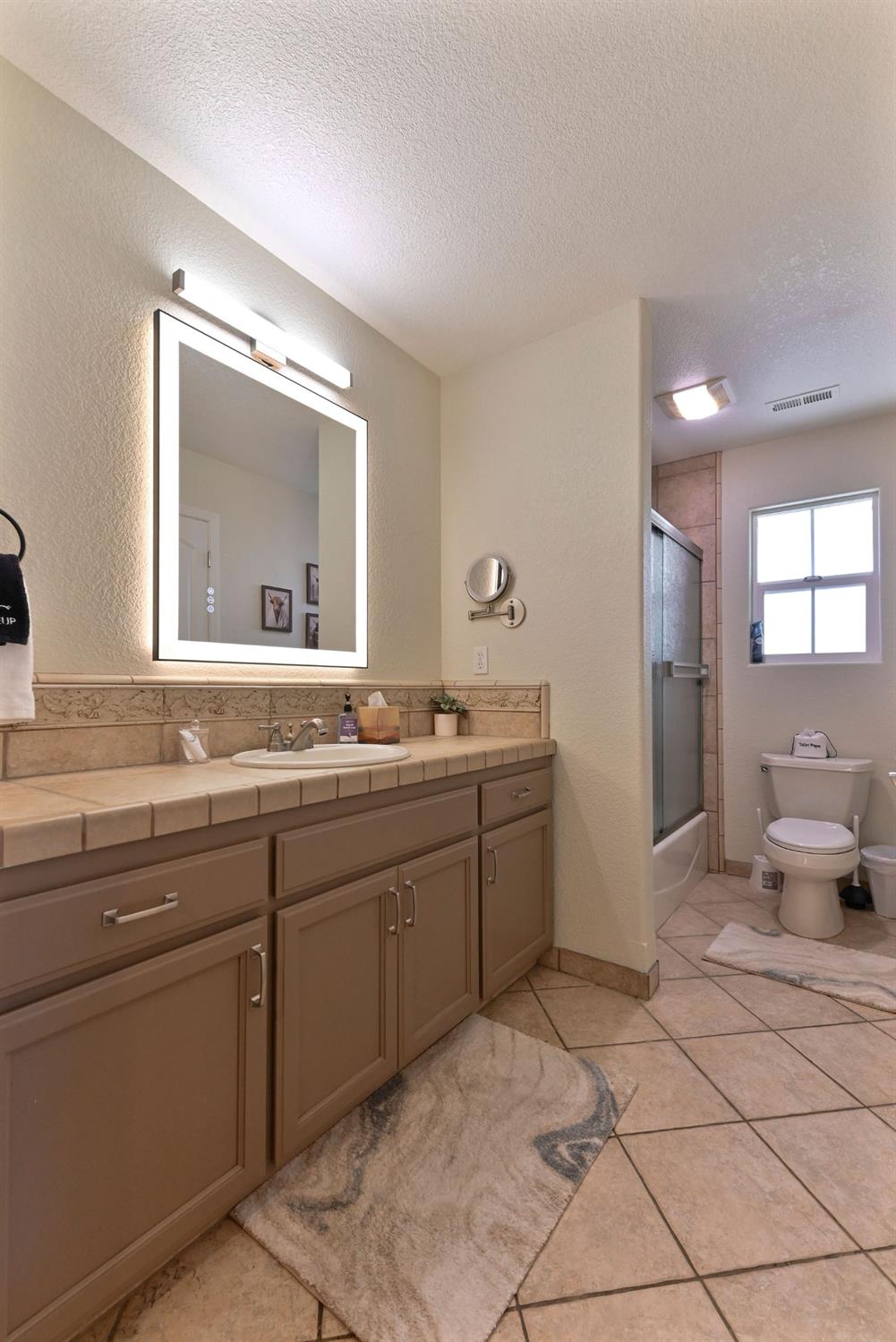 333 Oak Tree Circle Murphys, CA 95247 - Photo 37 of 88 a bathroom with a granite countertop sink a toilet and mirror