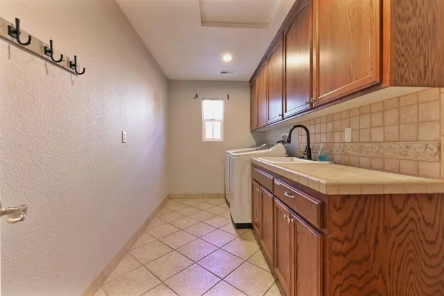 a view of a patio with table and chairs and potted plants