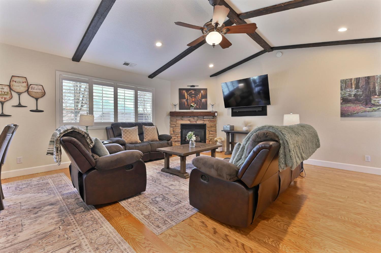 333 Oak Tree Circle Murphys, CA 95247 - Photo 5 of 88 a living room with furniture a flat screen tv and a fireplace