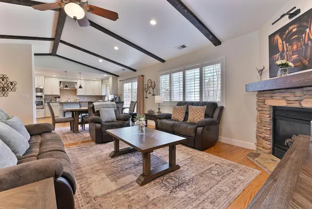 a living room with furniture a flat screen tv and a fireplace