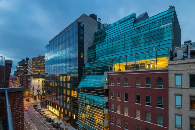 a view of a brick building next to a yard