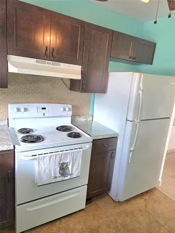 a stove top oven sitting inside of a kitchen