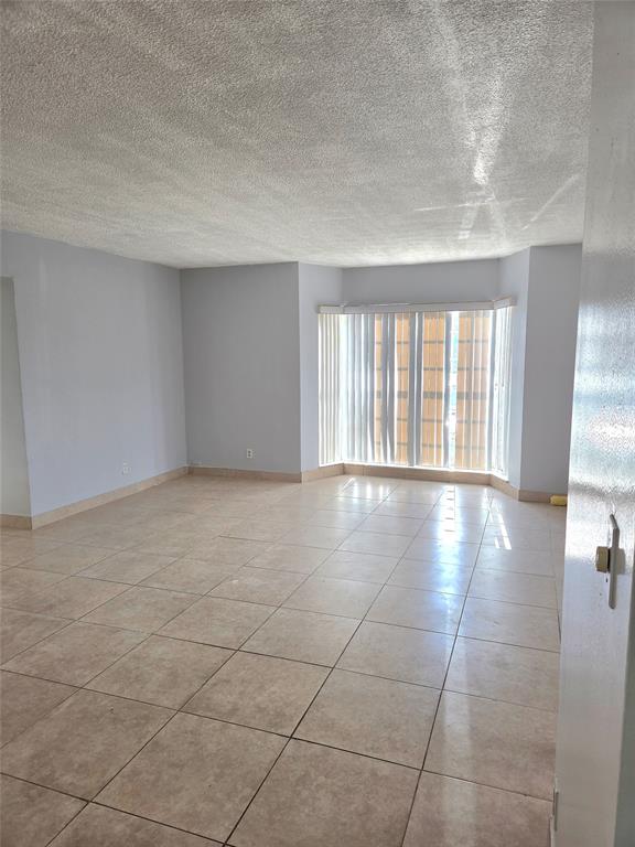 1971 Southeast 5th Court, Unit 101E Pompano Beach, FL 33060 - Photo 4 of 12 a view of an empty room with a window