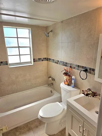a bathroom with a sink toilet and bathtub