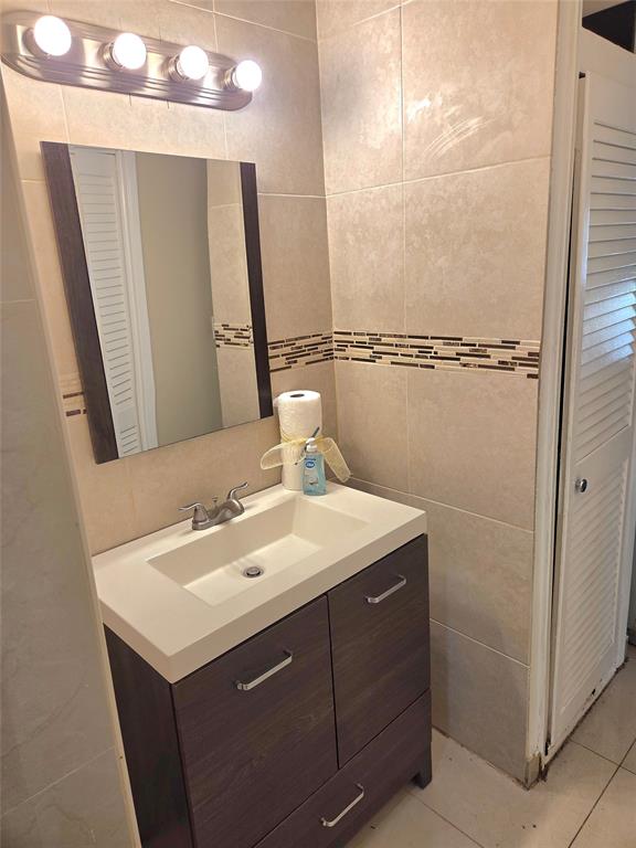 1971 Southeast 5th Court, Unit 101E Pompano Beach, FL 33060 - Photo 7 of 12 a bathroom with a sink and a mirror