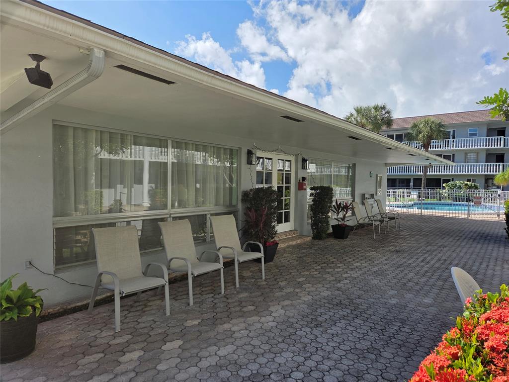 1971 Southeast 5th Court, Unit 101E Pompano Beach, FL 33060 - Photo 10 of 12 a view of a chairs and table in the patio