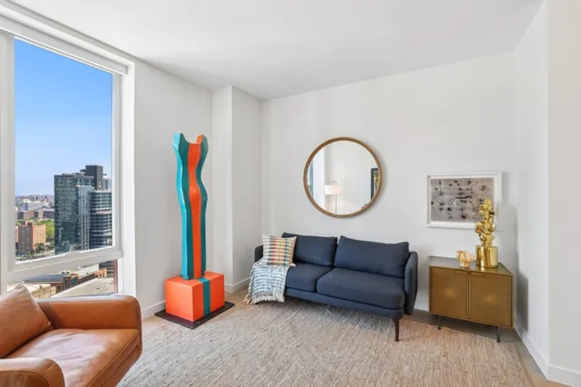 a living room with furniture a mirror and a window