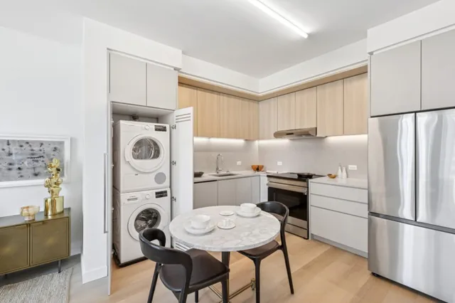 a kitchen with refrigerator a stove a sink and a refrigerator