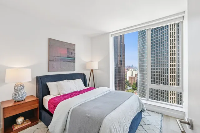 a bedroom with a balcony a bed and a window
