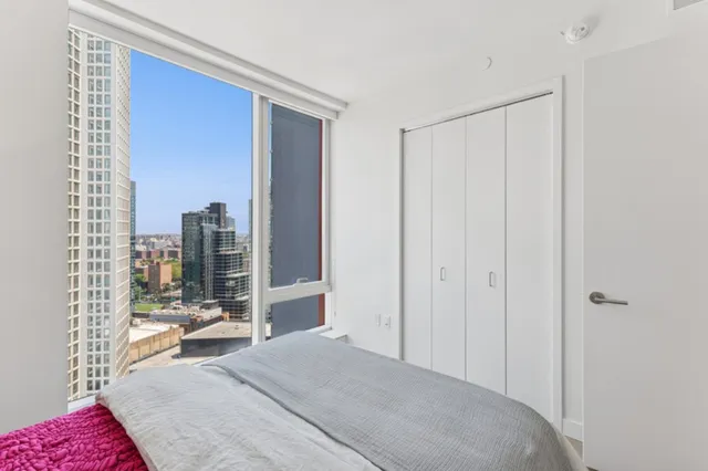 a bedroom with a bed and glass door