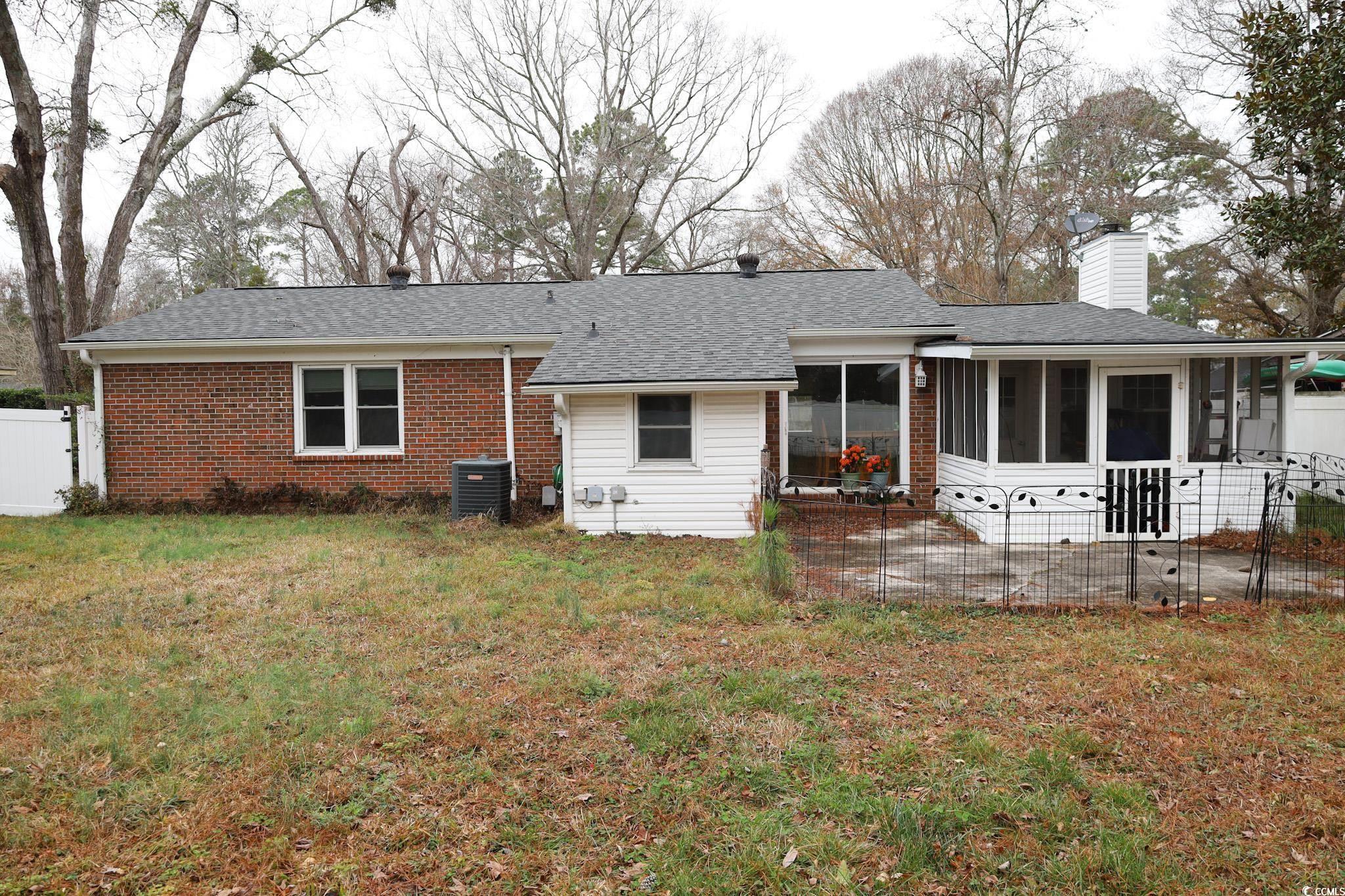 4649 Tarpon Bay Road Myrtle Beach, SC 29579 - Photo 20 of 24 Rear view of property with cooling unit, a yard, a