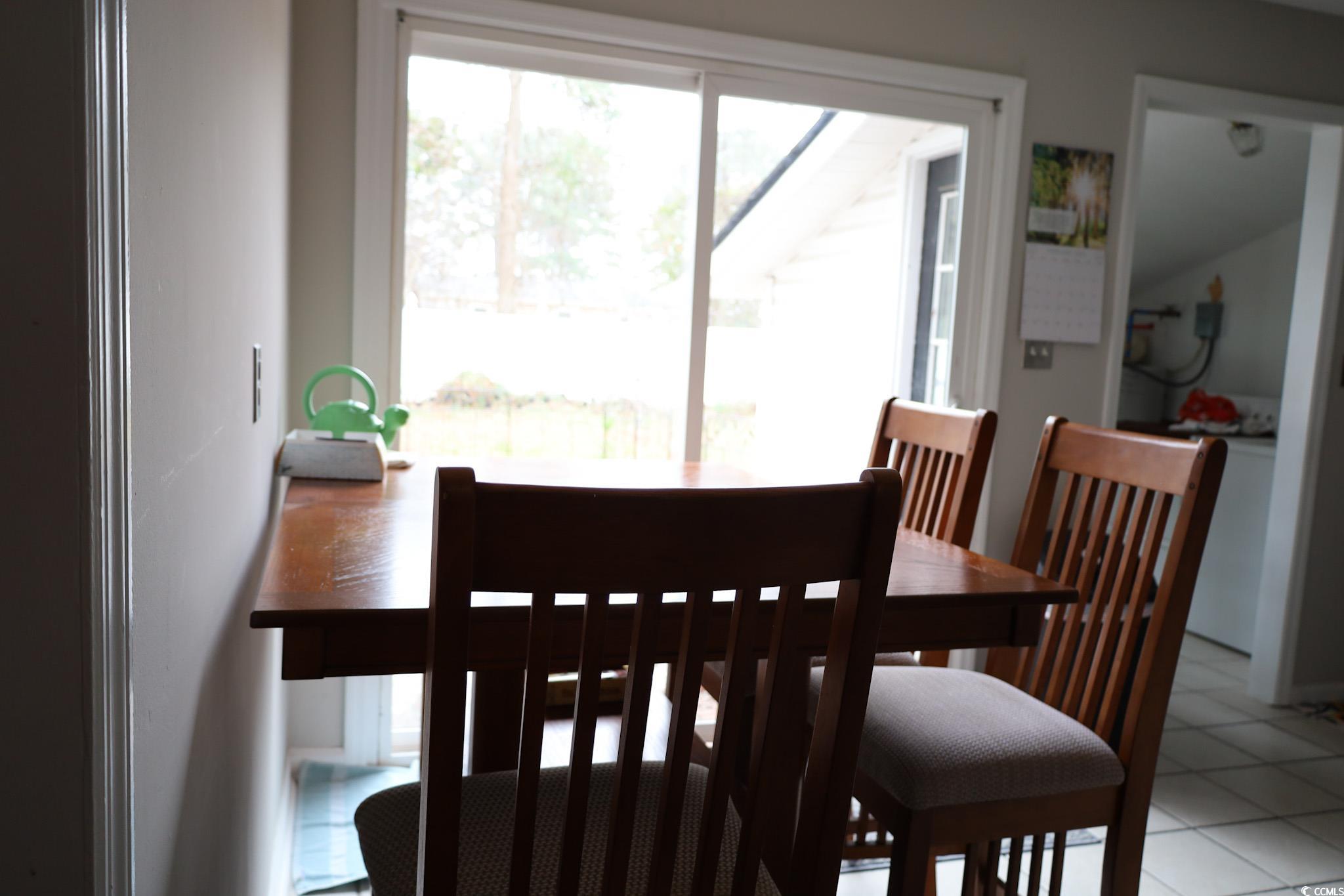 4649 Tarpon Bay Road Myrtle Beach, SC 29579 - Photo 6 of 24 Tiled dining space featuring a healthy amount of s