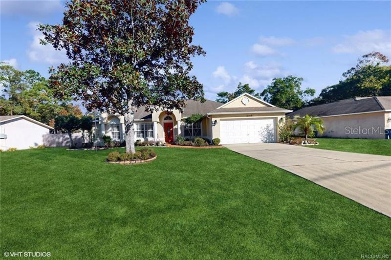 10183 Elgin Boulevard Spring Hill, FL 34608 - Photo 1 of 1 a front view of a house with garden