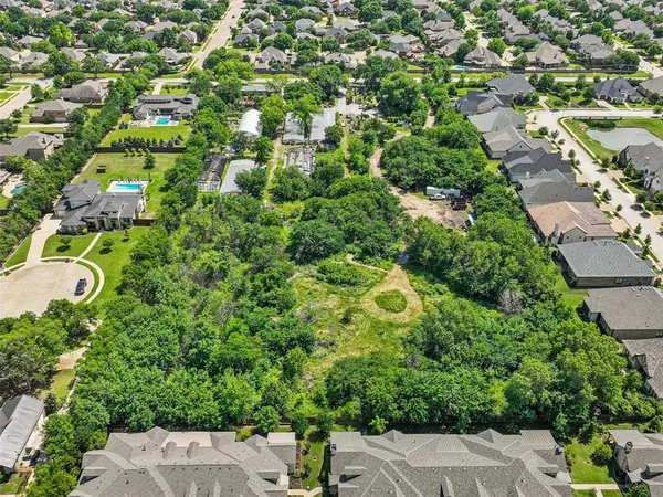 an aerial view of a house with yard