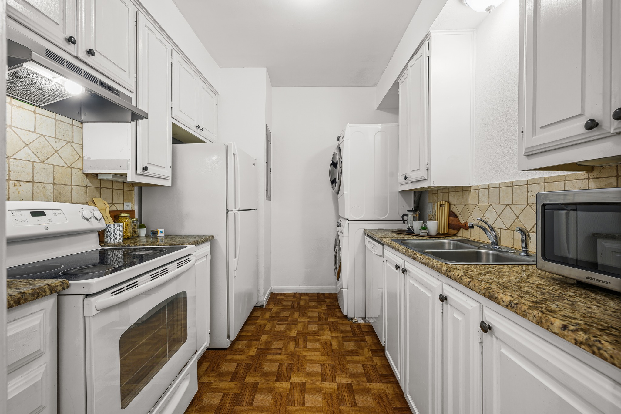 2529 Rio Grande Street, Unit 12 Austin, TX 78705 - Photo 4 of 24 a kitchen with stainless steel appliances granite countertop a stove a sink and a refrigerator