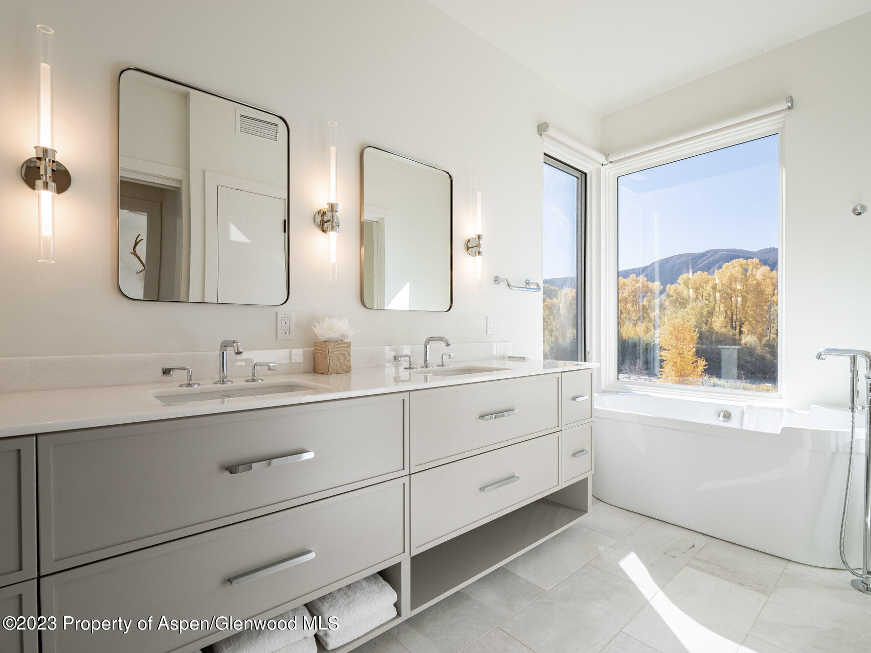 22858 Two Rivers Road Basalt, CO 81621 - Photo 26 of 40 a bathroom with a double vanity sink and mirror with bathtub
