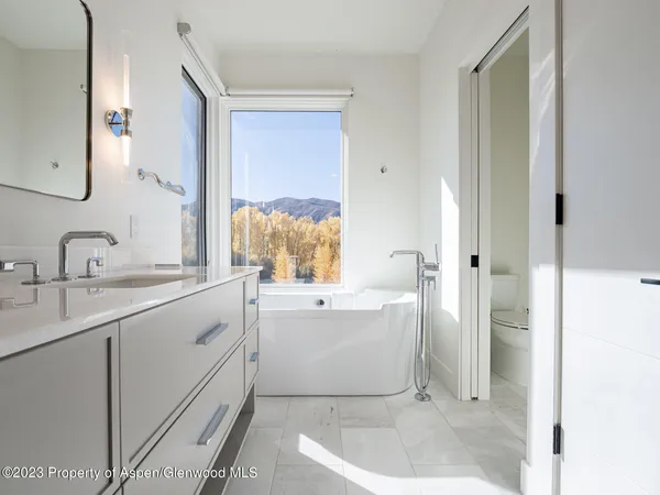 a bathroom with a double vanity sink mirror and shower