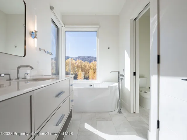 a bathroom with a double vanity sink mirror and shower