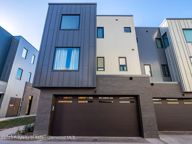 a view of a big house with a fountain in a yard