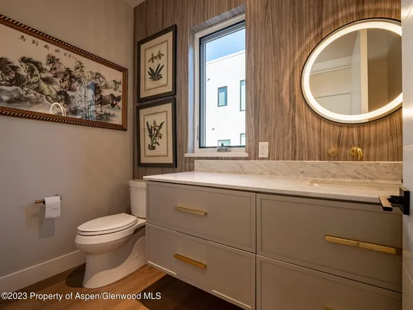 a bathroom with a toilet a sink and a mirror
