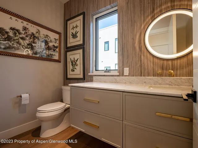 a bathroom with a toilet a sink and a mirror