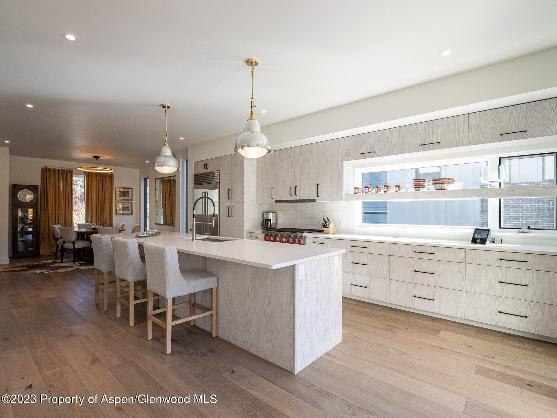 22858 Two Rivers Road Basalt, CO 81621 - Photo 9 of 40 a large white kitchen with lots of white furniture