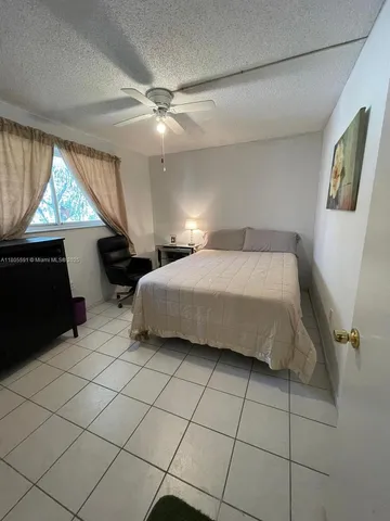 a spacious bedroom with a bed and a window