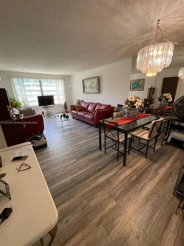 a living room with furniture a window and a table