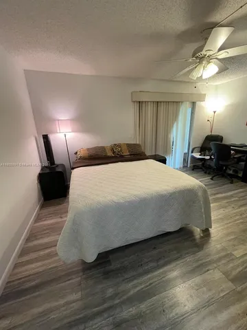 a bedroom with a bed and a lamp